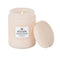 lit large 18oz. coconut papaya scented candle in a light pink embossed vessel