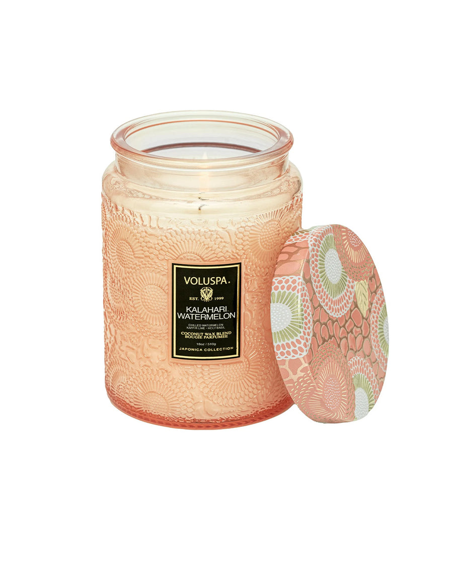 large 18oz. watermelon scented candle in a coral embossed vessel with the lid off