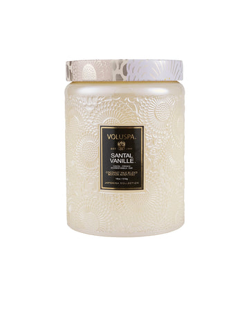 large 18oz. santal vanilla scented candle in a cream embossed vessel