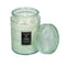 lit large 18oz. white cypress scented candle in a mint embossed vessel