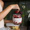 model pulling fruit from 24 oz cream terrazzo seal tight glass bowl with lid