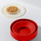kernels in lid of red silicone reusable popcorn popper
