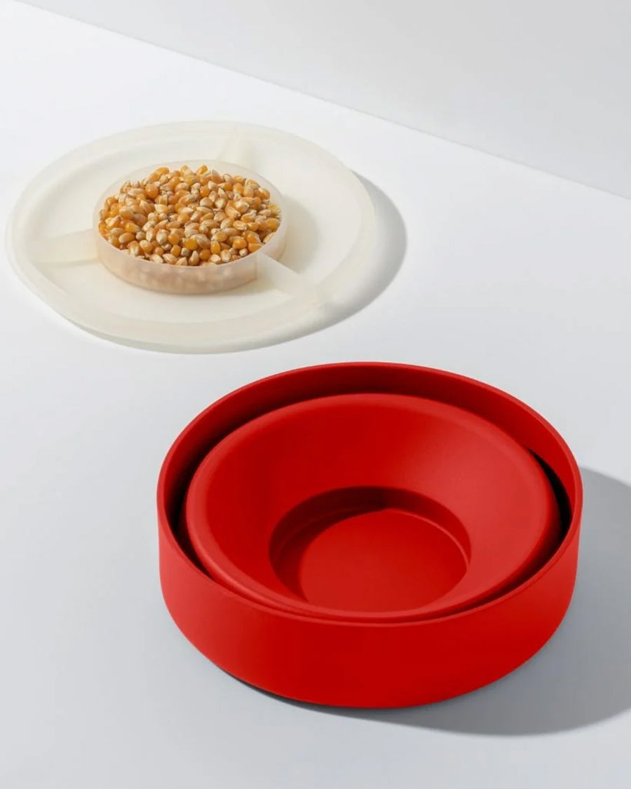 kernels in lid of red silicone reusable popcorn popper