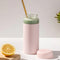 glass wide mouth water bottle with blush silicone grip sleeve and matching lid with green shake inside