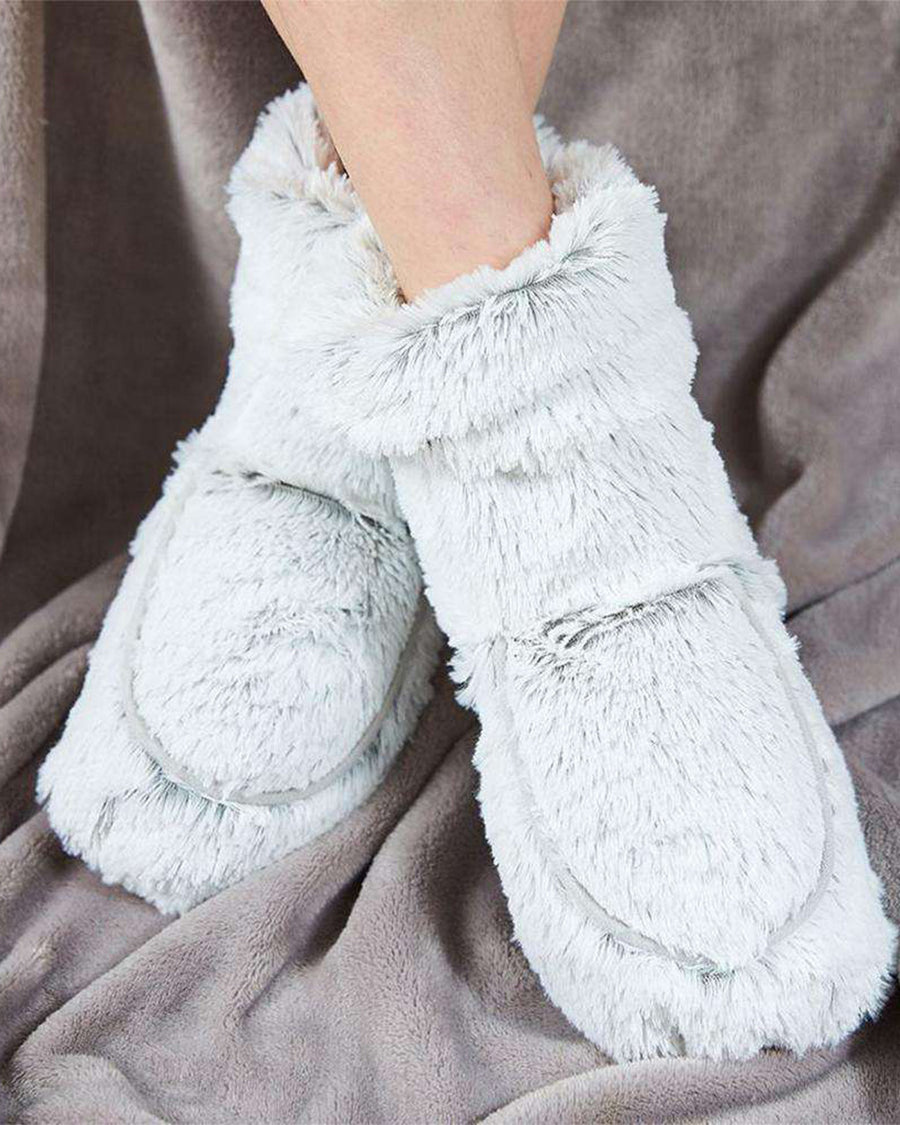 model wearing gray fuzzy microwavable booties