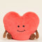 pink heart-shaped plush toy with brown arms and legs