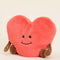 side view of pink heart-shaped plush toy with brown arms and legs