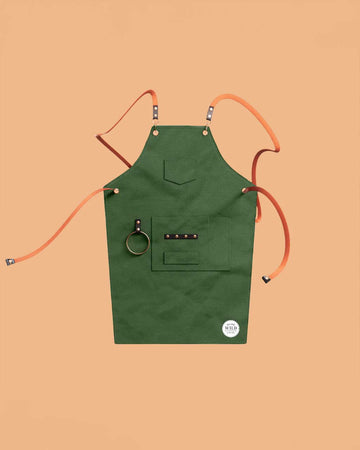 green apron with leather straps and front pockets