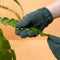 model wearing dark green leaf cleaning gloves