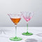 set of two pink tulip shaped champagne glasses with drink inside