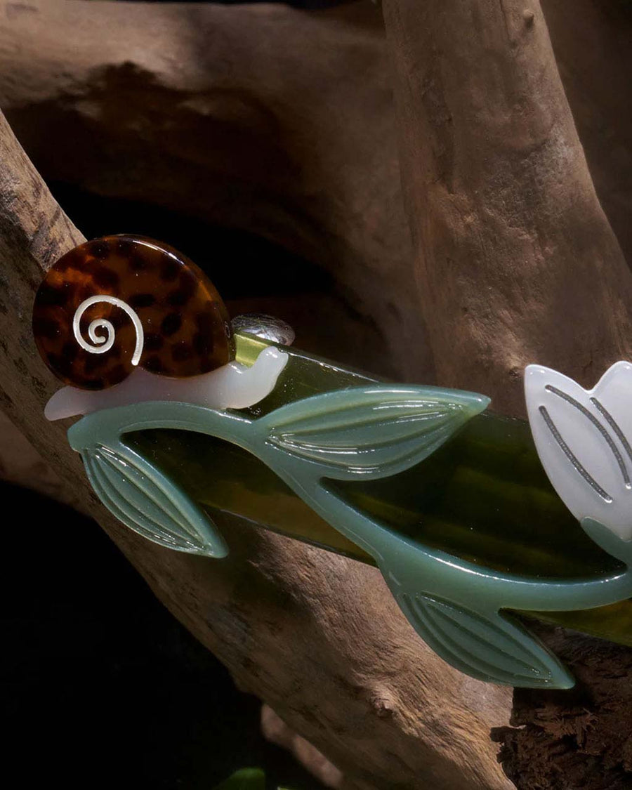 up close of green french barrette with tortoise shell snail details