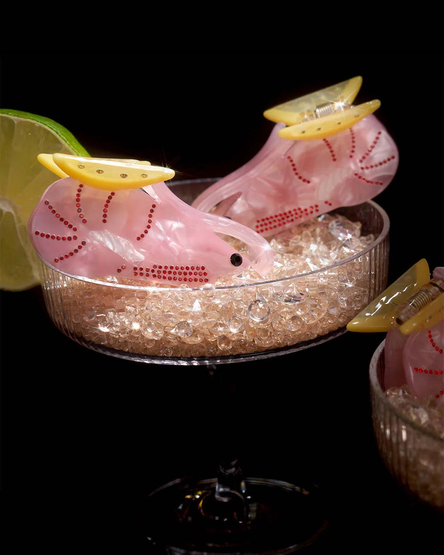 pink cajun shrimp hair claw with lemon detail on top in glass