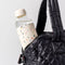 20 oz. glass water bottle with white terrazzo silicone cover sticking out of a bag