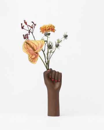 hand vase with flowers sticking out of the hands