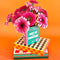 green and pink book ceramic vase: meet me at the bookstore by ban.do with pink flowers inside