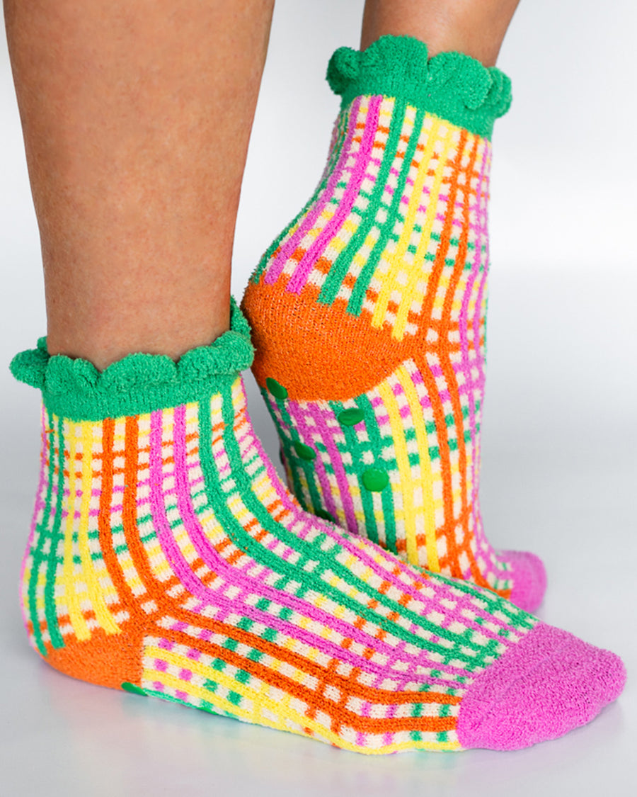 model wearing multicolor grid print chenille socks with green riffle and grip bottoms