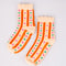 cream chenille socks with ruffle top with orange stripes and multicolor dots