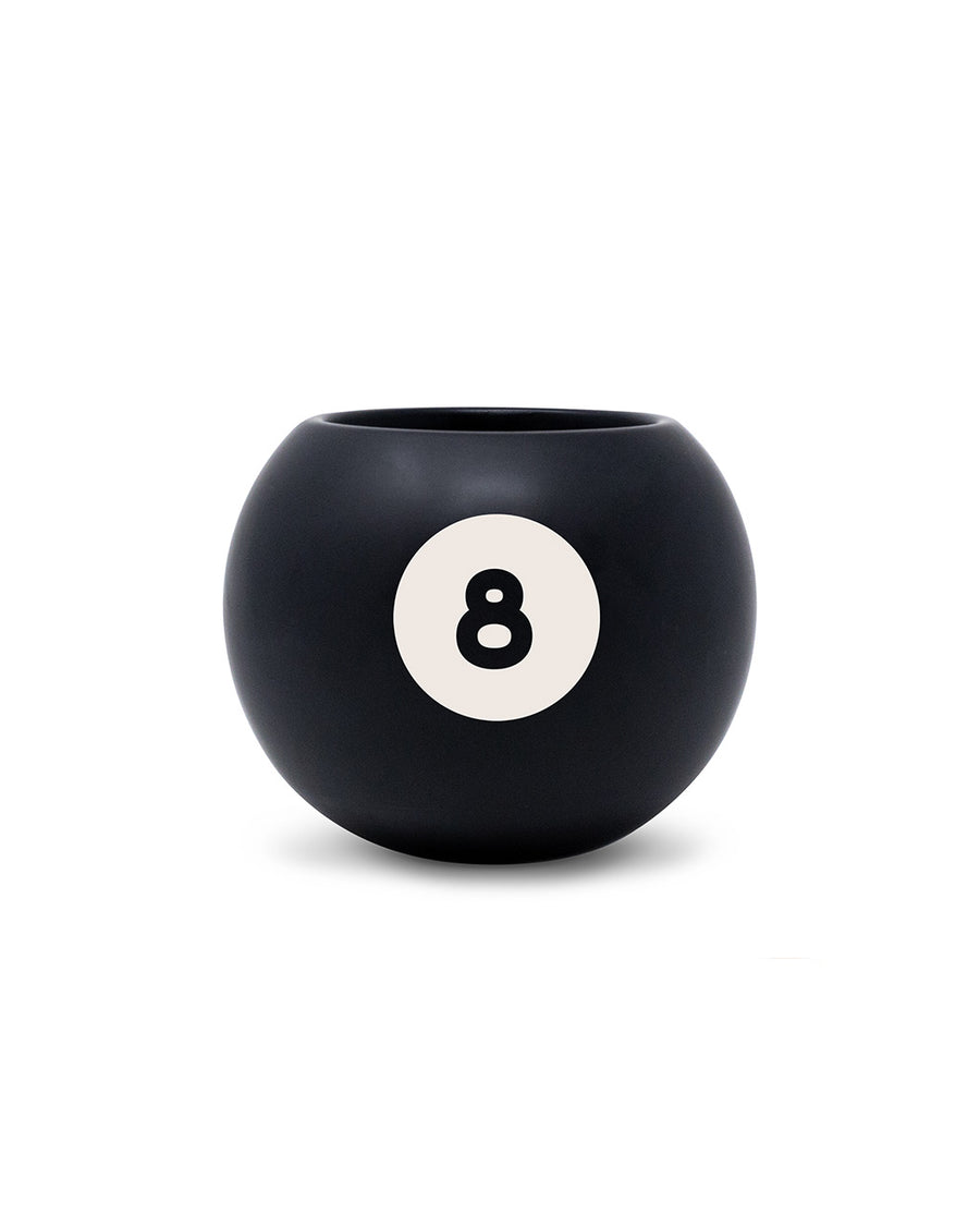 black magic 8 ball shaped vase with pens inside