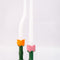 orange and pink tulip candle holder with white taper candles inside