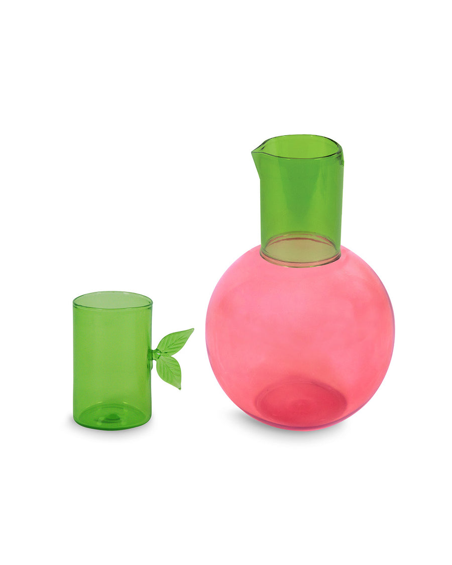 separated lid on pink cherry shaped carafe with green lid/cup with leaf detail