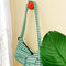 red cherry hook with green gingham purse hanging from it