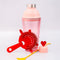 pink bar shaker with red heart top, red strainer, and yellow stirring stick