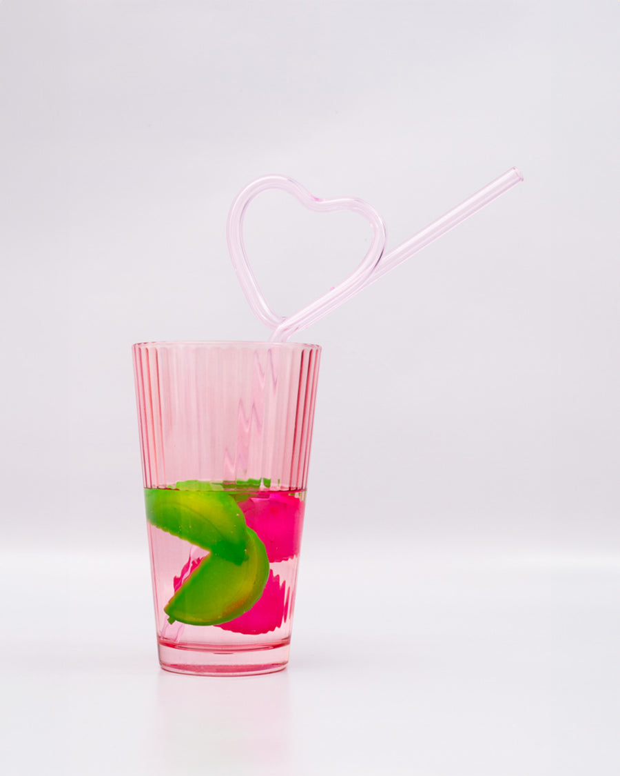 light pink glass heart shaped straw in a glass