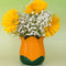 orange tulip shaped pencil holder with flowers inside