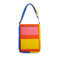 front of pink, yellow, red, and blue quilted laptop tote with various pockets