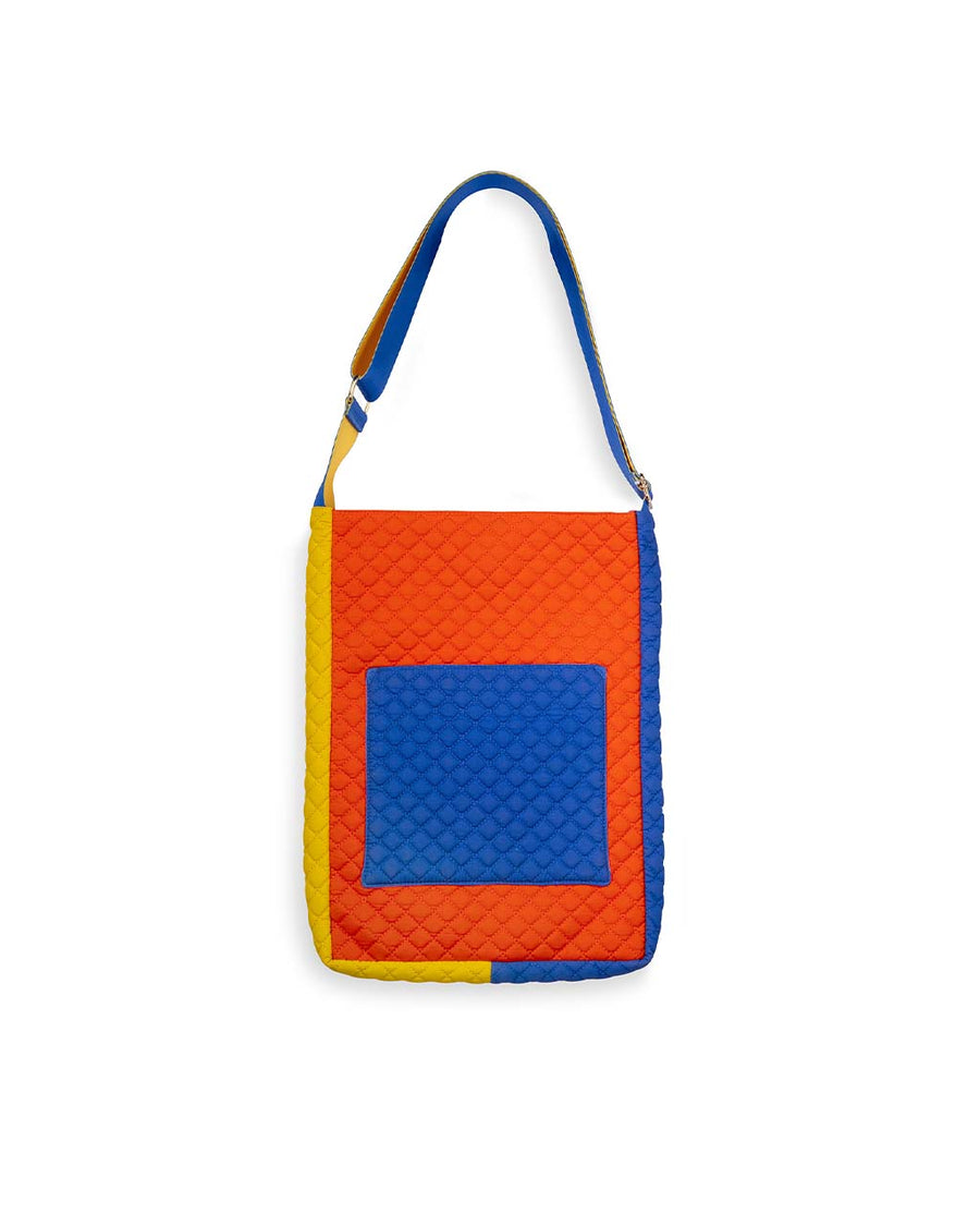 back view of pink, yellow, red, and blue quilted laptop tote with various pockets