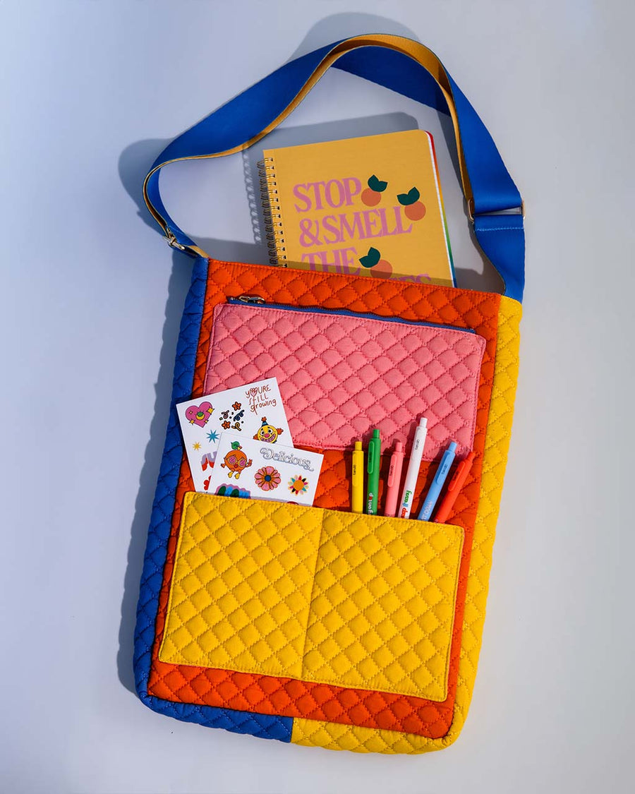 pink, yellow, red, and blue quilted laptop tote with various pockets