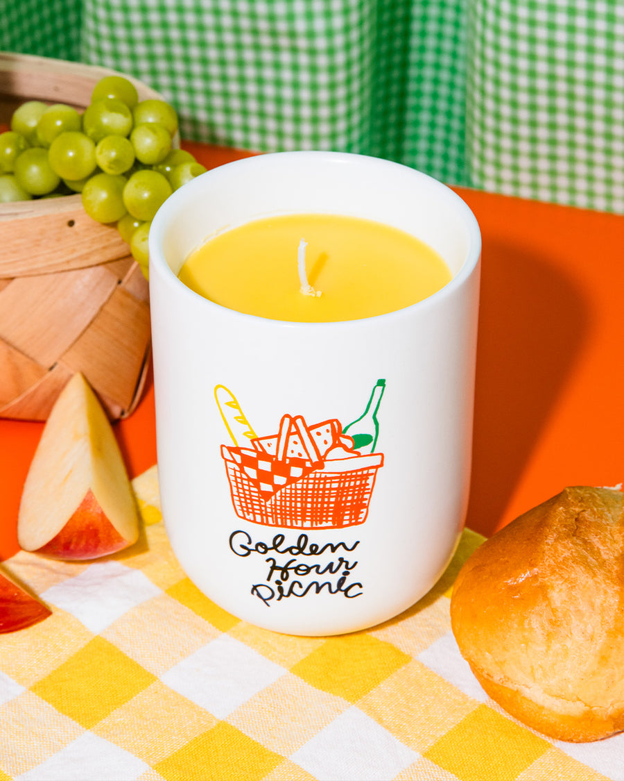 strawberry and berries scented candle with 'golden hour picnic' and picnic image on the front