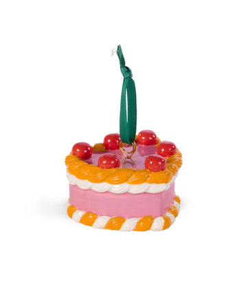 ceramic pink cake shaped ornament with orange and white trim and 'cherries on top' 