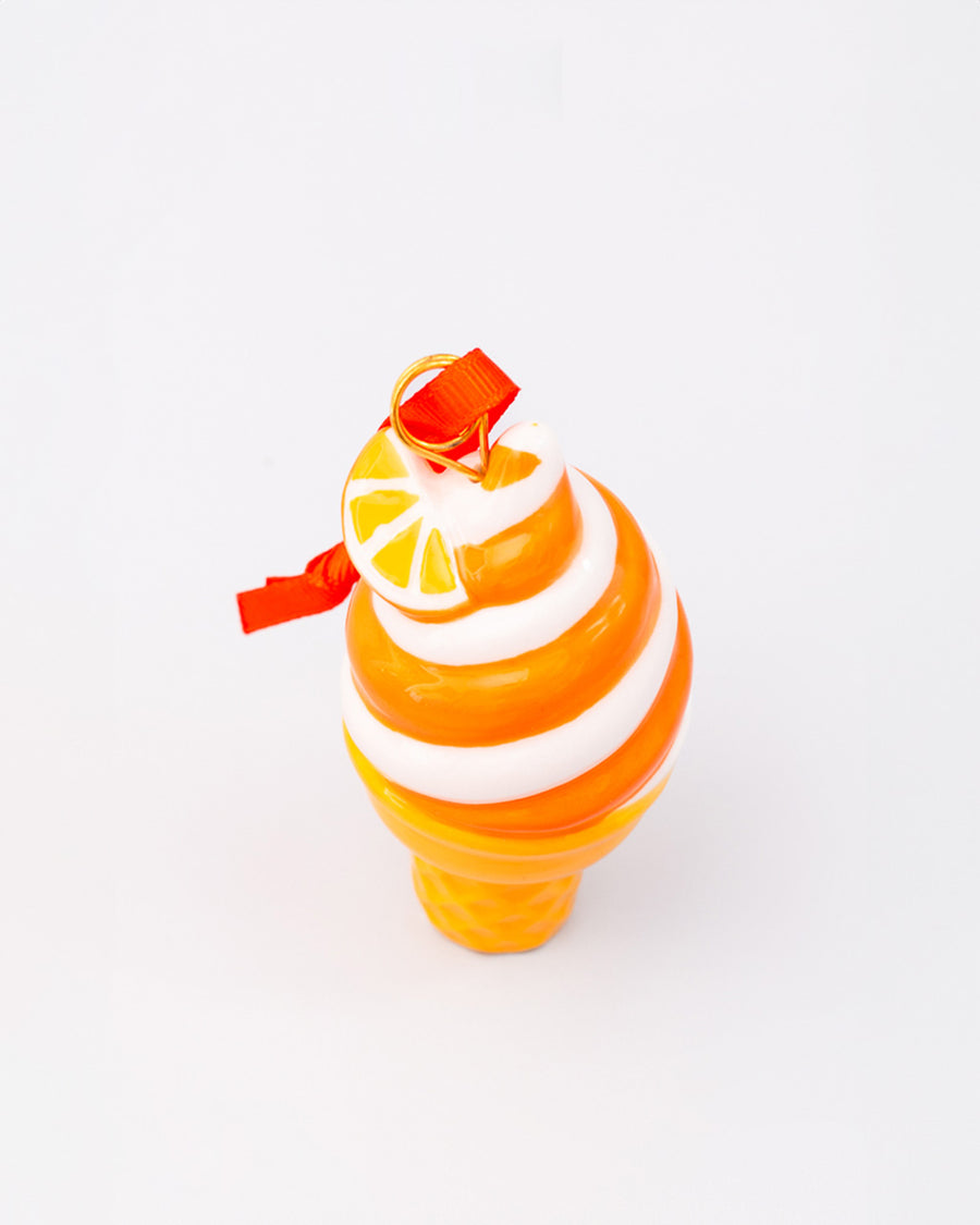 top view of ceramic orange and white swirled ice cream cone ornament