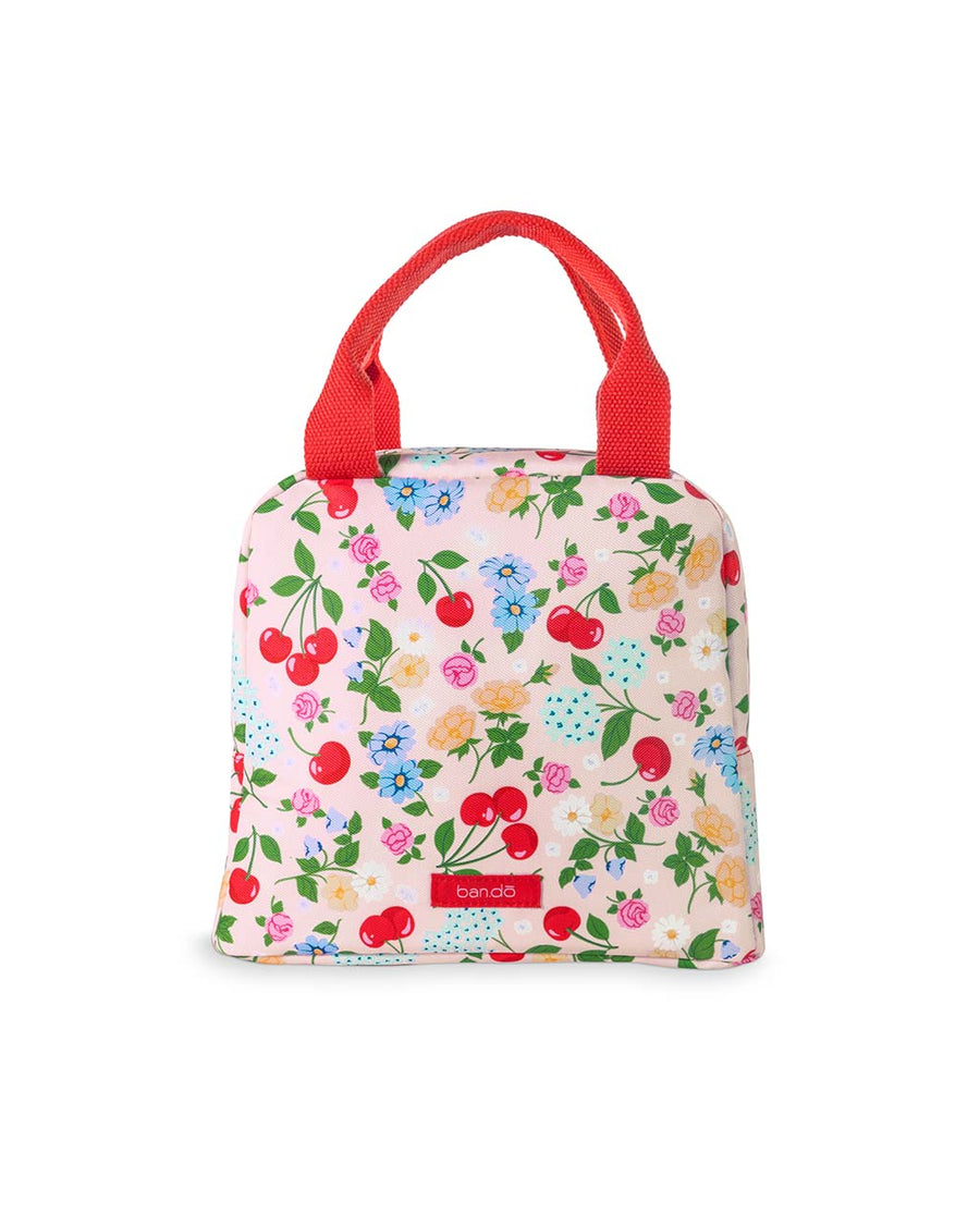 light pink lunch tote with all over cherry and flower print and red handles