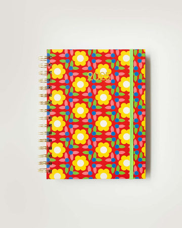 red 12-month planner with colorful yellow quilt floral print and lime green elastic strap