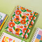 cream 17-month planner with colorful floral and cherry print surrounded by planners