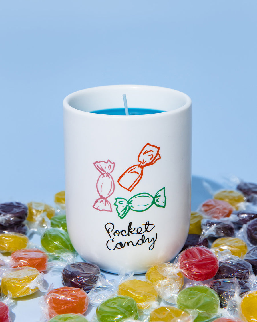 sweet scented candle with 'pocket candy' across the front surrounded by wrapped candy