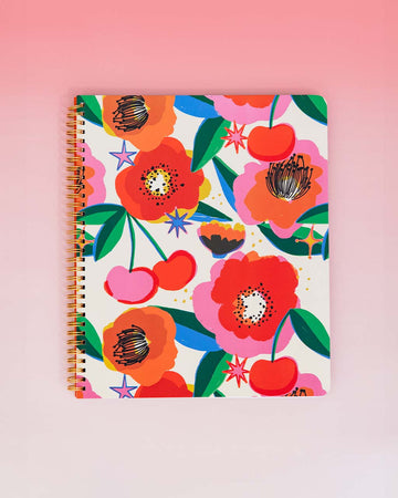 pale yellow large notebook with abstract floral and cherry print on a red gradient gorund