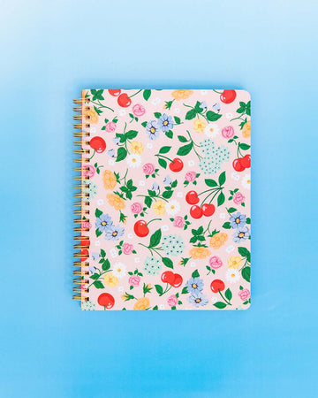 light pink mini notebook with cherry and floral print on blue background