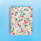 light pink mini notebook with cherry and floral print on blue background