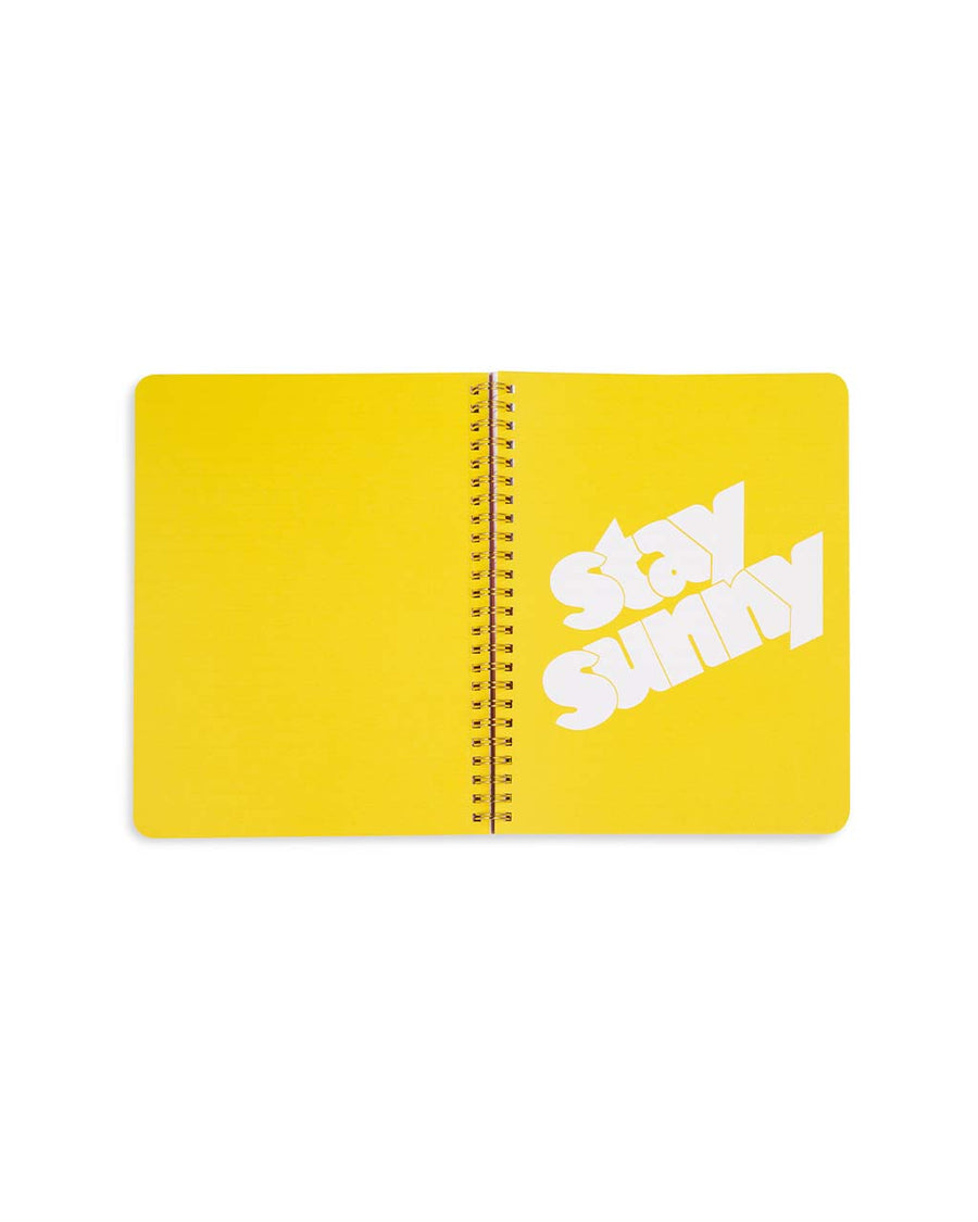 yellow centerfold that has white 'stay sunny' typography across the front