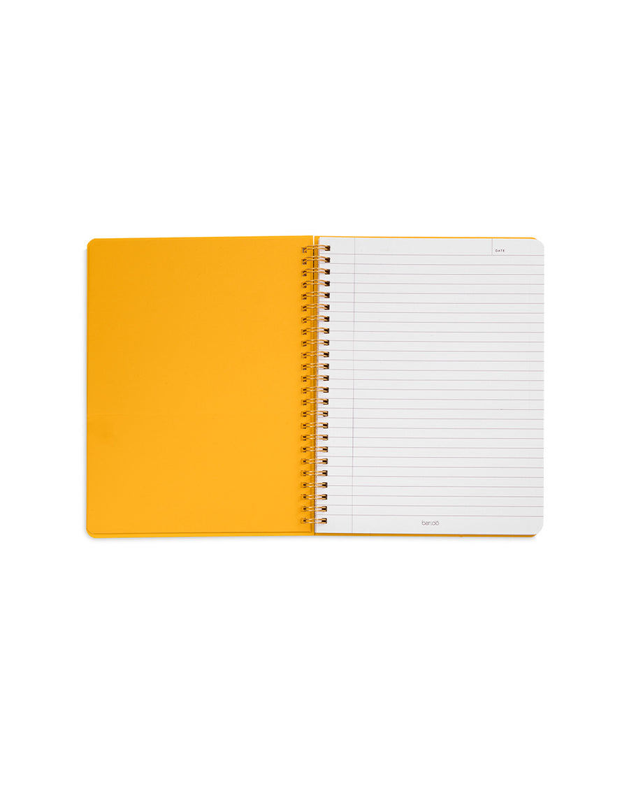 yellow interior of white mini notebook with colorful patchwork design