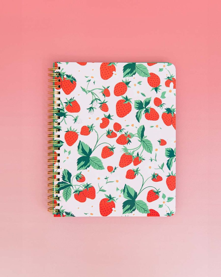 light pink mini notebook with all over strawberry print on pink ombre background