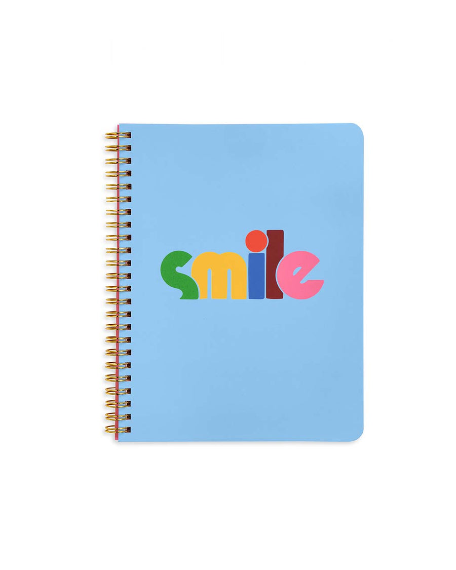 baby blue mini notebook with rainbow 'smile' typography across the front