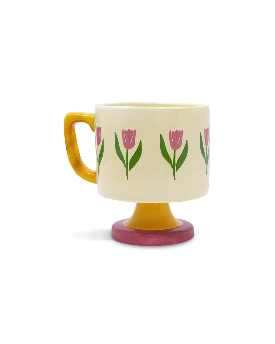 cream 10 oz ceramic mug with yellow handle, pink pedestal base and pink tulip print