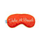 red satin eye mask with cursive 'take a break' across the front