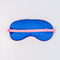 dark blue silk back of dark green sleep mask with pink and white embroidered 'greeting from paradise' with pink adjustable strap