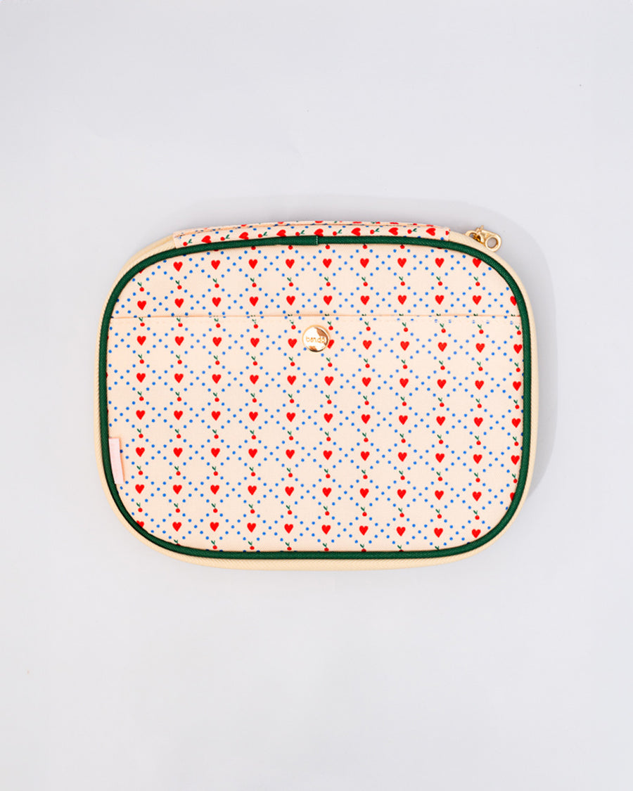 cream mobile tech pouch with red heart quilted pattern with dark green trim