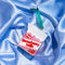 ceramic strawberry milk carton ornament on a blue satin background